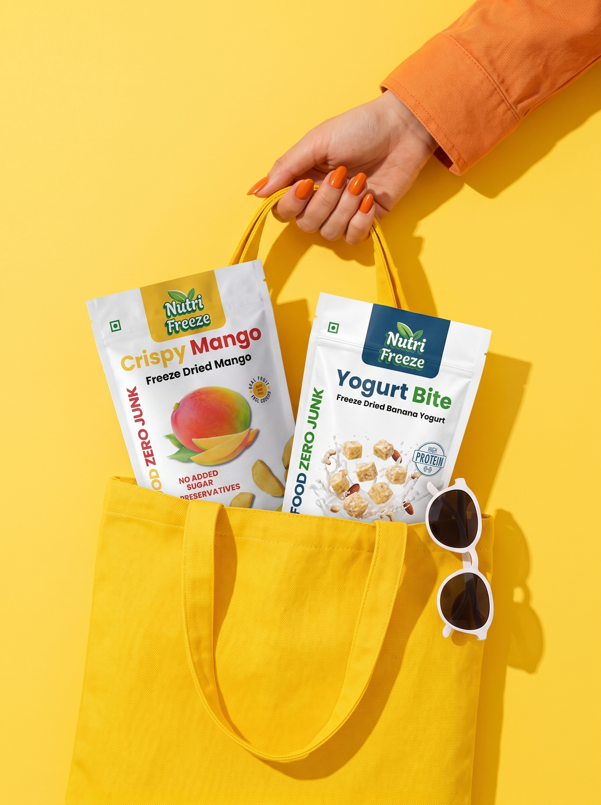 Mango and banana yogurt pouches in a yellow tote, ready for a day out